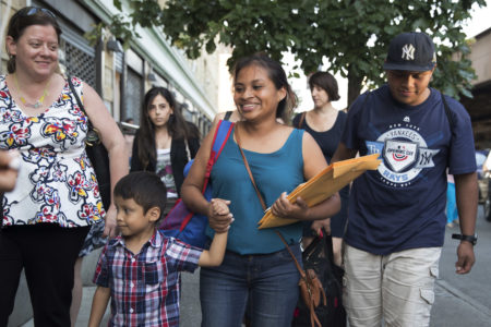 Julie Schwietert-Collazo, left, of Immigrant Families Together, walks with Rosayra Pablo Cruz, center, as she leaves the Cayuga Center with her sons 5-year-old Fernando, second from left, and 15-year-old Jordy, Friday, July 13, 2018, in New York.