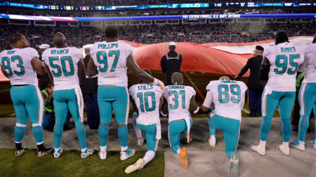 Miami Dolphins players kneel during the national anthem before their game against the Carolina Panthers at Bank of America Stadium on Nov. 13, 2017, in Charlotte, N.C.