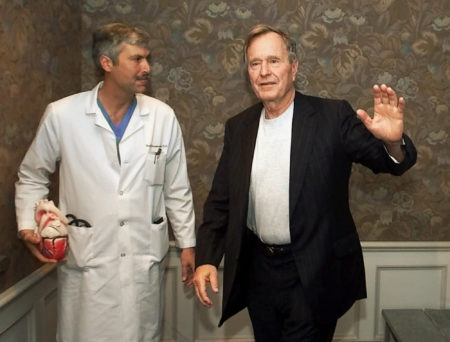FILE - In this Feb. 25, 2000, file photo, former President George H.W. Bush waves as he leaves Methodist Hospital with his cardiologist, Mark Hausknecht, after a news conference in Houston. Hausknecht, who once treated former President George H.W. Bush, was fatally shot by a fellow bicyclist Friday, July 20, 2018, while riding through a Houston medical complex, and police were trying to determine if the shooting was random or a targeted act.