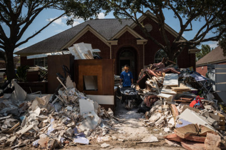 Miguel Lameda removed flood damaged debris from a relative’s home in the Canyon Gate at Cinco Ranch neighborhood of Houston.