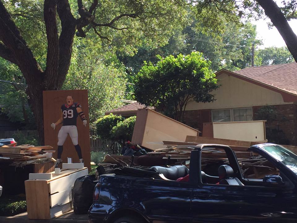 JJ Watt Sign in Front of a Flooded House