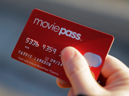 Cassie Langdon holds her MoviePass card outside AMC Indianapolis 17 theatre in Indianapolis on Jan. 30. MoviePass, the discount service for movie tickets, announced it will not be raising prices but will be capping theater visits at three per month