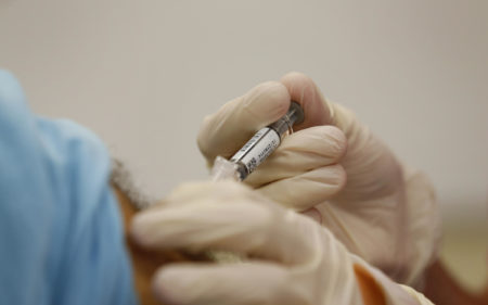 A pharmacist gives a senior citizen a flu shot in September 2013 in Houston, Texas.