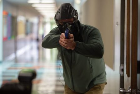 An educator partakes in a simulated shooting as part of a training for school marshals. School marshals are school staff trained and armed to take out a threat to their campus.