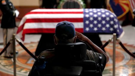 A former serviceman salutes the casket during a memorial service for Sen. John McCain at the Arizona Capitol on in Phoenix.