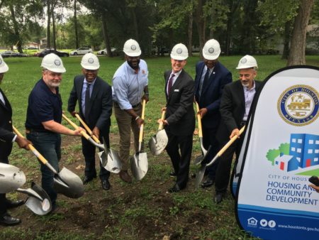 Houston Mayor Sylvester Turner, third from left, council members, housing officials and developers break ground to new affordable houses in Acres Homes.