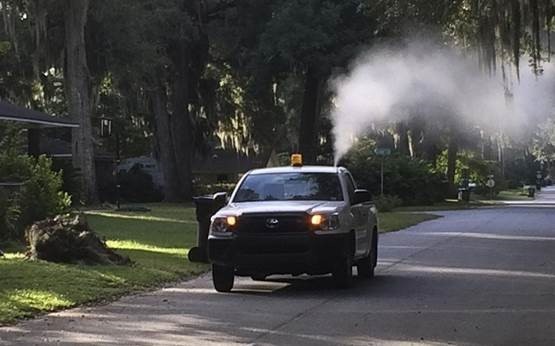 A truck sprays for mosquitoes in a Missouri City neighborhood.