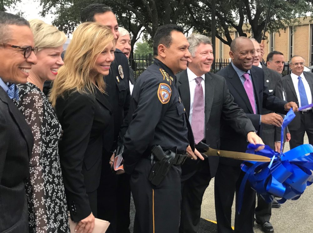 Public officials gather at 1215 Dennis Street for the official ribbon cutting of the new diversion center. 