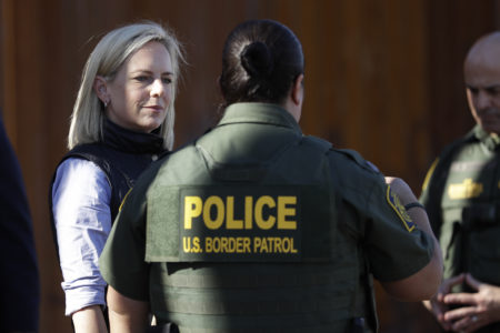 U.S. Department of Homeland Security Secretary Kirstjen Nielsen, left, speaks with Border Patrol agents near a newly fortified border wall structure Friday, Oct. 26, 2018, in Calexico, Calif. (AP Photo/Gregory Bull)