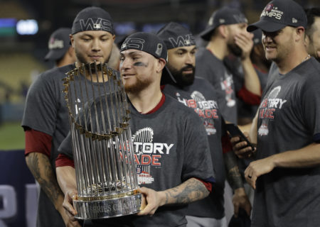Boston Red Sox catcher Christian Vazquez holds the championship trophy after Game 5 of the World Series on Sunday, Oct. 28, in Los Angeles.