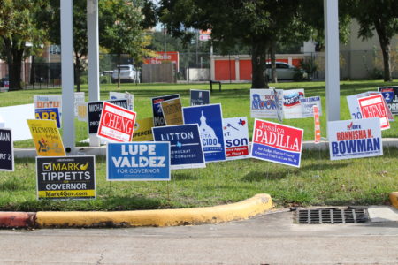 Outside of the Metropolitan Multi-Service Center voting location in Montrose, campaign posters cover the grass.