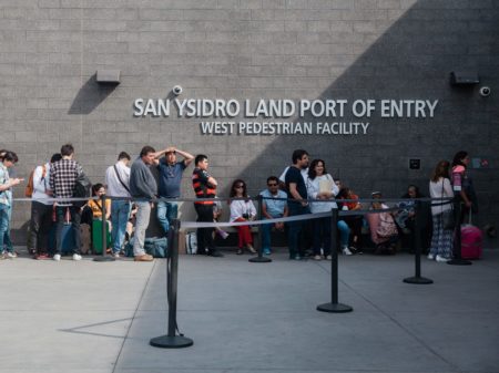 People wait in line outside the San Ysidro Port of Entry, between Tijuana, Mexico, and San Diego, Calif., in October.