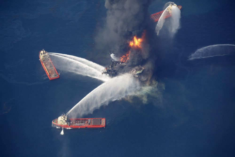 FILE - In this April 21, 2010, aerial file photo, the Deepwater Horizon oil rig burns in the Gulf of Mexico, more than 50 miles southeast of Venice on Louisiana's tip. Environmental activists Karen Savage and Cherri Foytlin wrote an article criticizing a company that published a study finding no connection between chemicals released by the explosion and health problems reported by some cleanup workers. Massachusetts' highest court will hear arguments Oct. 7, 2016, in a bid by Savage and Foytlin to throw out a defamation lawsuit filed by the company, siting a state law that protects citizens exercising their free speech rights. (AP Photo/Gerald Herbert, File)