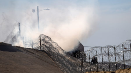Tear gas thrown by the U.S. Border Patrol is seen near the El Chaparral/San Ysidro border crossing in Tijuana, Mexico, on Sunday