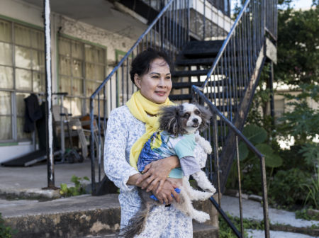 Hien Tran, 66, and her dog Lucy at the Thai Xuan Village apartment complex in Houston.