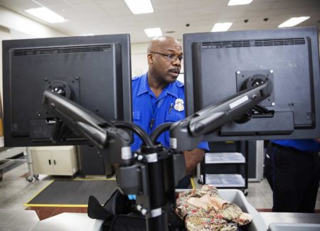 A TSA officer looks at a monitor while checking a bag in the screening lane at Hartsfield-Jackson Atlanta International Airport, May 25, 2016, in Atlanta. In 2017, TSA found more guns in carry-ons at the airport than at any other.