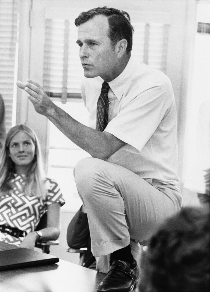 In this Oct. 9, 1970 file photo, Rep. George H.W. Bush, R-Texas, talks with a group of young people at a rally in Houston, Texas. 