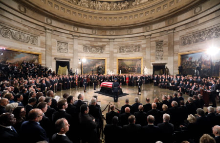 The flag-draped casket of former President George H.W. Bush lies in state in the Capitol Rotunda in Washington, Monday, Dec. 3, 2018. (Jonathan Ernst/Pool via AP)