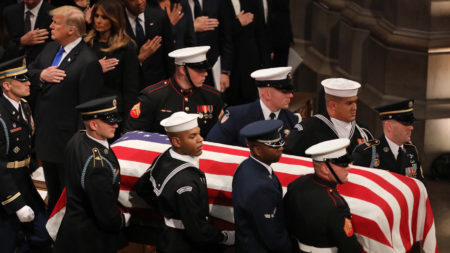 A military honor guard carries the casket of former President George H.W. Bush during the funeral at the National Cathedral in Washington, D.C.