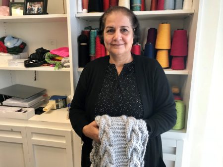 Ilham Dawood has been knitting scarfs, headbands and hats for nearly ten years through Community Cloth.