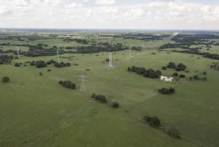 A proposed high-speed rail would be built along existing power lines for much of its length between Dallas and Houston. But many project opponents say a state agency should be involved in a private company's use of eminent domain.