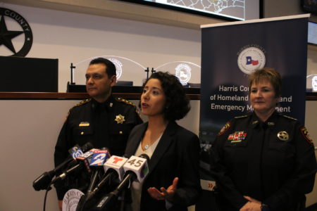 Harris County Judge Lina Hidalgo (center) speaks to reporters before a briefing from emergency officials on December 20, 2018.