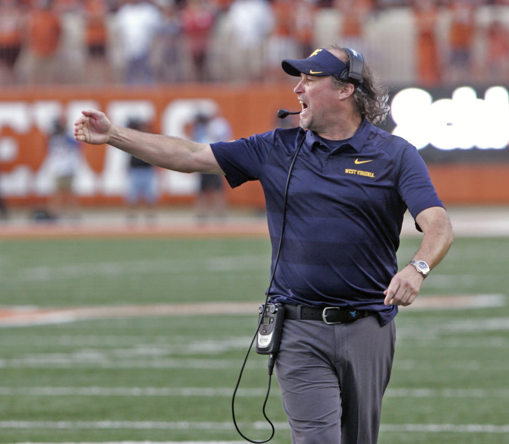 FILE - In this Nov. 3, 2018, file photo, West Virginia head coach Dana Holgorsen calls out to his team during the second half of an NCAA college football game against Texas, in Austin, Texas. Houston has hired West Virginia’s Dana Holgorsen as its coach, Wednesday, Jan. 2, 2019, ending his eight-year run with the Mountaineers. (AP Photo/Michael Thomas, File)