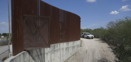 In this Aug. 11, 2017, photo, a U.S. Customs and Border Patrol vehicle passes along a section of border levee wall in Hidalgo, Texas.