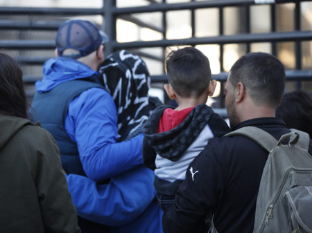 Honduran asylum seekers enter the U.S. at San Diego's Otay Mesa port of entry, as seen from Tijuana, Mexico.