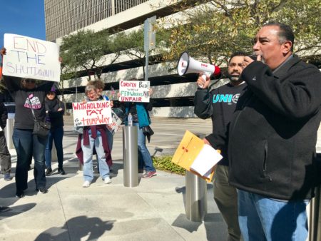 Protesters and furloughed government workers rally outside Senator Ted Cruz's office in downtown Houston, urging for an end to the shutdown.