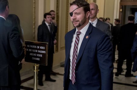 Rep. Dan Crenshaw, R-Texas, walks through the halls on Capitol Hill in Washington, Wednesday, Jan. 16, 2019.