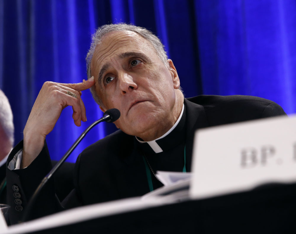 FILE - In this Nov. 12, 2018, file photo, Cardinal Daniel DiNardo of the Archdiocese of Galveston-Houston, president of the United States Conference of Catholic Bishops, listens to a reporter's question during a news conference during the USCCB's annual fall meeting in Baltimore. Prosecutors investigating a sexual abuse case against DiNardo are executing a search warrant at the offices of the local archdiocese, led by DiNardo, the cardinal leading the Catholic Church's response in the U.S. to sexual misconduct. Investigators from the Montgomery County District Attorney's Office were at the offices Wednesday, Nov. 28, 2018, of the Archdiocese of Galveston-Houston. (AP Photo/Patrick Semansky, File)