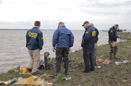 NTSB investigators on shoreline of Trinity Bay examining wreckage from the Feb. 23, 2019 cargo jet crash in Texas.