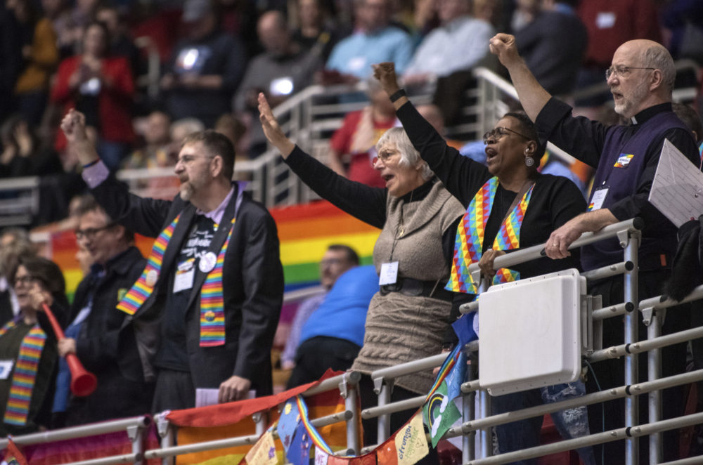 Protestors chant during the United Methodist Church's special session of the general conference in St. Louis, Tuesday, Feb. 26, 2019. America's second-largest Protestant denomination faces a likely fracture as delegates at the crucial meeting move to strengthen bans on same-sex marriage and ordination of LGBT clergy. (AP Photo/Sid Hastings)