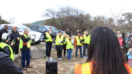 Comanche Trail Community Association President Pedro Martinez debriefs with organizers and participants when Saturday's mock wildfire evacuation was finished.