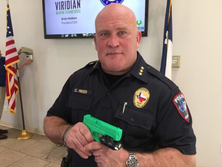 Kemah police Chief Chris Reed holds a fake gun with the Viridian weapon-mounted camera.