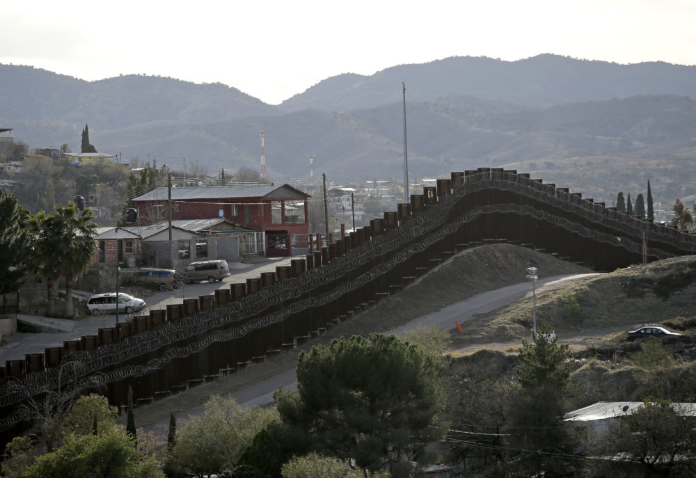 The president declared a national emergency in February to access federal money to build a wall similar to this razor-wire-covered border wall separating Nogalas, Mexico (left), and Nogales, Ariz. Congress did not approve the full amount he asked for last year to follow through on a key campaign pledge.