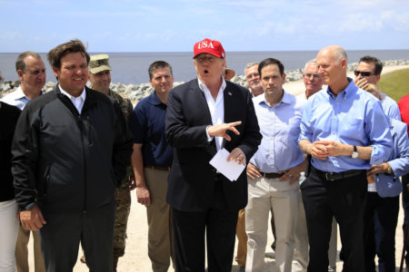 Sen. President Donald Trump with, from left, Florida Gov. Ron DeSantis, Sen. Marco Rubio, R-Fla., and Rick Scott, R-Fla., speaks to reporters during a visit Lake Okeechobee and Herbert Hoover Dike at Canal Point, Fla., Friday, March 29, 2019.
