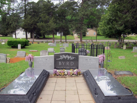 This Friday, April 12, 2019 photo shows the gravesite of James Byrd Jr. in Jasper, Texas. Byrd was killed on June 7, 1998, after he was chained to the back of a pickup truck and dragged for nearly three miles along a secluded road in the piney woods outside Jasper in what is considered one of the most gruesome hate crime murders in recent Texas history. In front of Byrd's gravesite, which was surrounded by a fence after being twice desecrated, sit the burial plots for his mother and father. Byrd's mother, Stella, died in 2010, while his father, James Sr., is still alive and resides in Jasper.