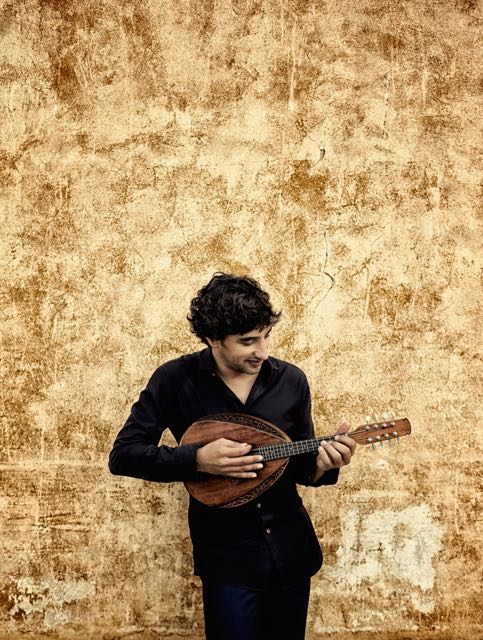 Publicity photo of Avi Avital playing mandolin