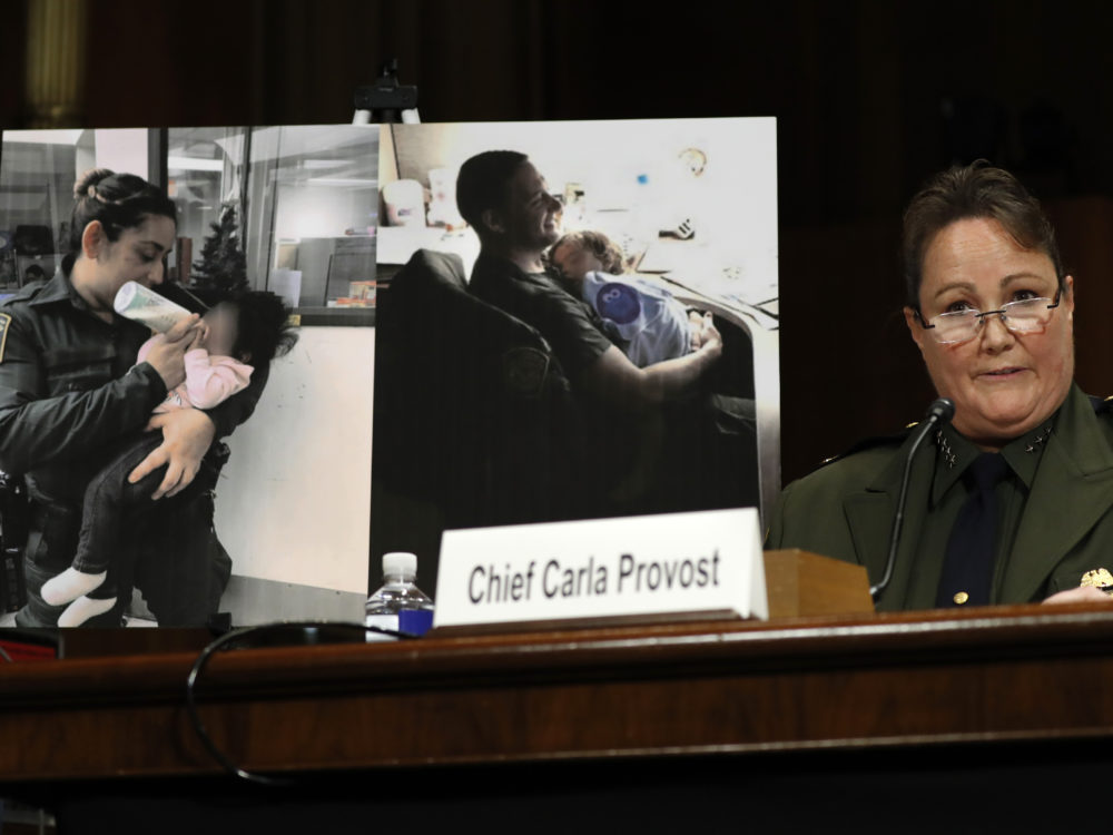 U.S. Border Patrol Chief Carla Provost testifies by a photo of agents with children during a Senate Judiciary Border Security and Immigration Subcommittee hearing.