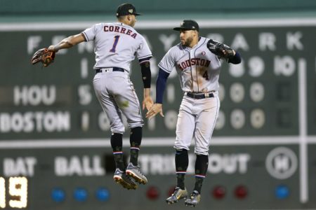 Houston Astros' Carlos Correa (1) and George Springer (4) celebrate after defeating the Boston Red Sox in a baseball game in Boston, Saturday, May 18, 2019.