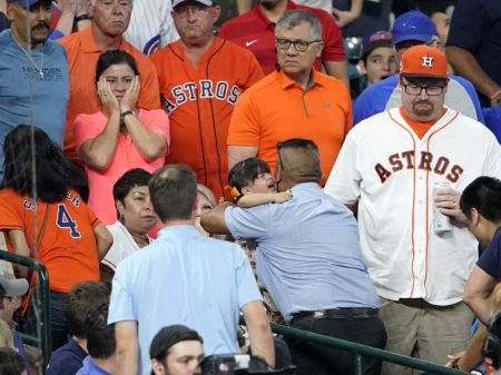A young child is carried from the stands after being injured by a foul ball off the bat of Chicago Cubs outfielder Albert Almora Jr. during the fourth inning of a baseball game against the Houston Astros Wednesday.