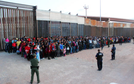 This May 29, 2019 file photo released by U.S. Customs and Border Protection (CBP) shows some of 1,036 migrants who crossed the U.S.-Mexico border in El Paso, Texas, the largest that the Border Patrol says it has ever encountered. The federal government is opening a new mass shelter for migrant children near the U.S-Mexico border and is considering housing children on three military bases to add 3,000 more beds to the overtaxed system in the coming weeks.