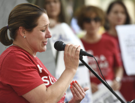 Jules Woodson, of Colorado Springs, Colo., speaks during a rally outside the Southern Baptist Convention's annual meeting Tuesday, June 11, 2019, in Birmingham, Ala. First-time attendee Woodson spoke through tears as she described being abused sexually by a Southern Baptist minister.