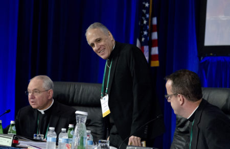 Cardinal Daniel DiNardo of the Archdiocese of Galveston-Houston, center, president of the United States Conference of Catholic Bishops, accompanied by Jose Gomez, archbishop of Los Angeles, left, and Rev. J. Brian Bransfield, right, get a sit before the morning prayer during the United States Conference of Catholic Bishops (USCCB), 2019 Spring meetings in Baltimore, Tuesday, Jun 11, 2019.