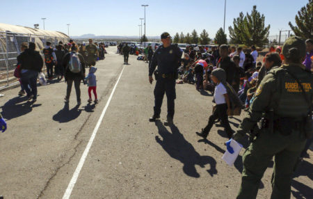 This May 29, 2019 photo released by U.S. Customs and Border Protection (CBP) shows some of 1,036 migrants who crossed the U.S.-Mexico border in El Paso, Texas, the largest that the Border Patrol says it has ever encountered. Video shows them going under a chain-link fence to the U.S., where they waited for agents to come. The Border Patrol has encountered 180 groups of more than 100 people since October, compared to 13 during the previous 12-month period and two the year before.