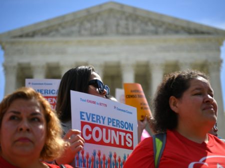 Demonstrators rally outside the U.S. Supreme Court in April to protest against the Trump administration's efforts to add a citizenship question to the 2020 census.