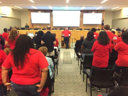Teachers and other school employees packed the HISD board auditorium to urge trustees to raise the minimum wage.