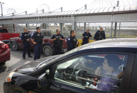 Customs and Border Protection agents survey cars entering the U.S., on the Puerta Mexico international bridge in Matamoros, Tamaulipas state, Mexico, Friday, June 28, 2019. Hundreds of migrants from Central America, South America, the Caribbean and Africa have been waiting for their number to be called at the bridge in downtown Matamoros, to have the opportunity to request asylum in the U.S.